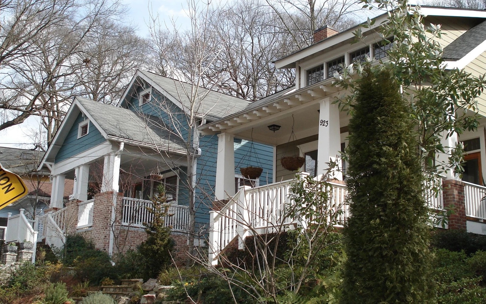 Two neighboring Atlanta bungalows with front porches, framed by bare trees.