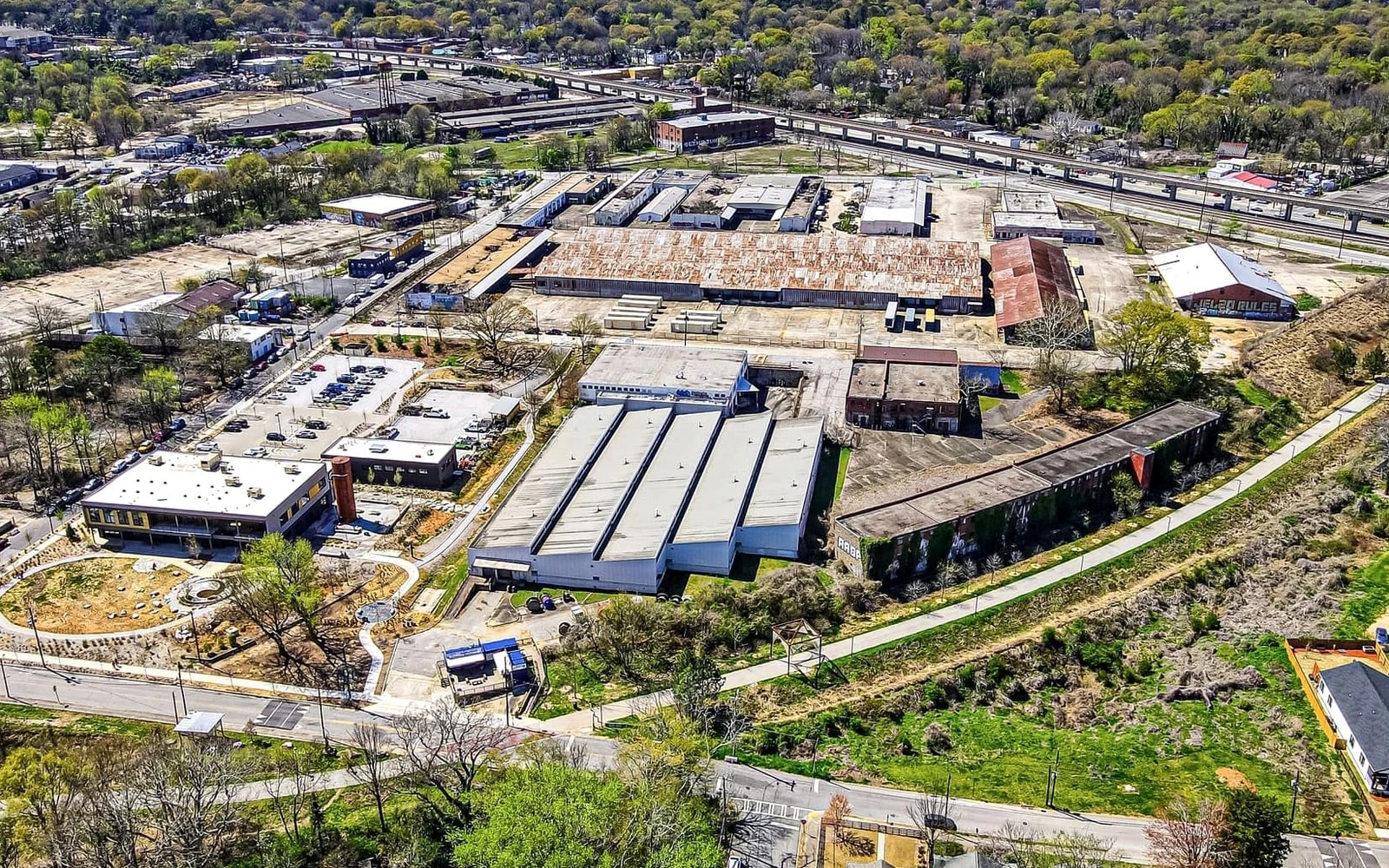 An aerial view of warehouse buildings, rail lines, roads and green space at Murphy Crossing in southwest Atlanta.