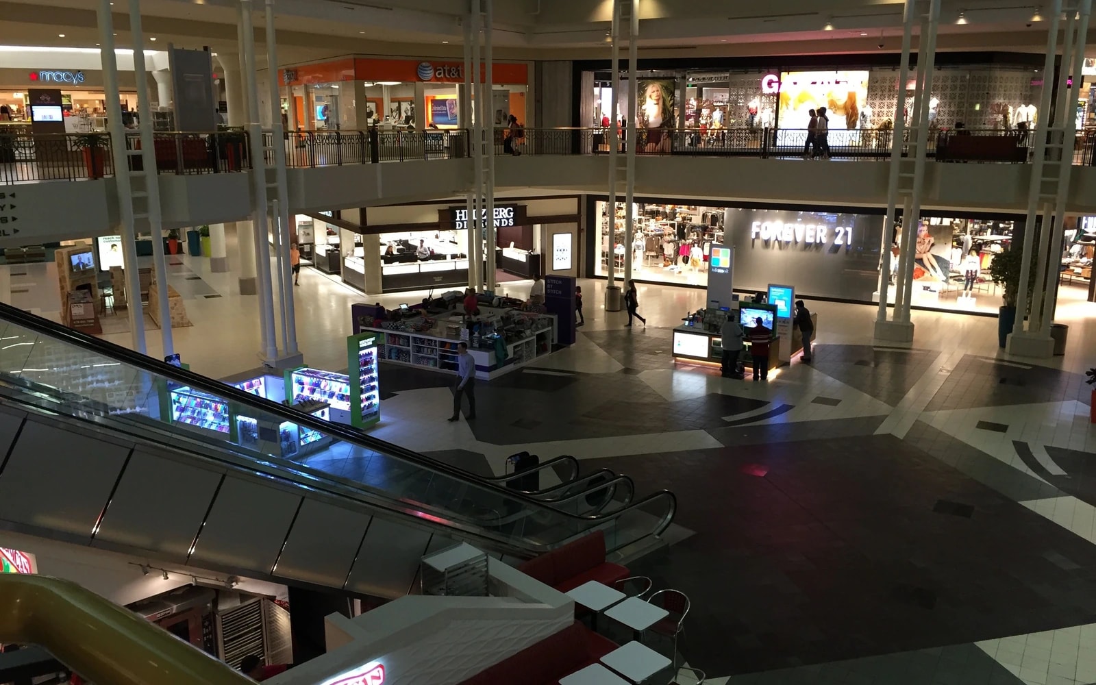 View from an upper level across North Point Mall’s multi-level interior, with storefronts and a few shoppers below.