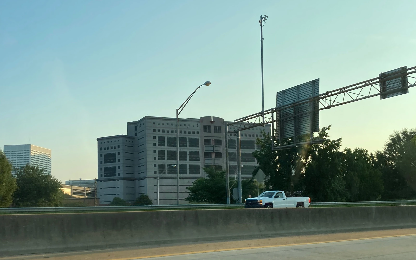 The Atlanta City Detention Center, a multistory building seen from beside a highway.